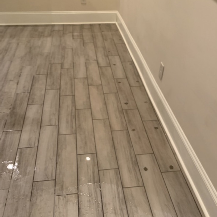 A completed basement featuring tile floors with foam injection waterproofing.